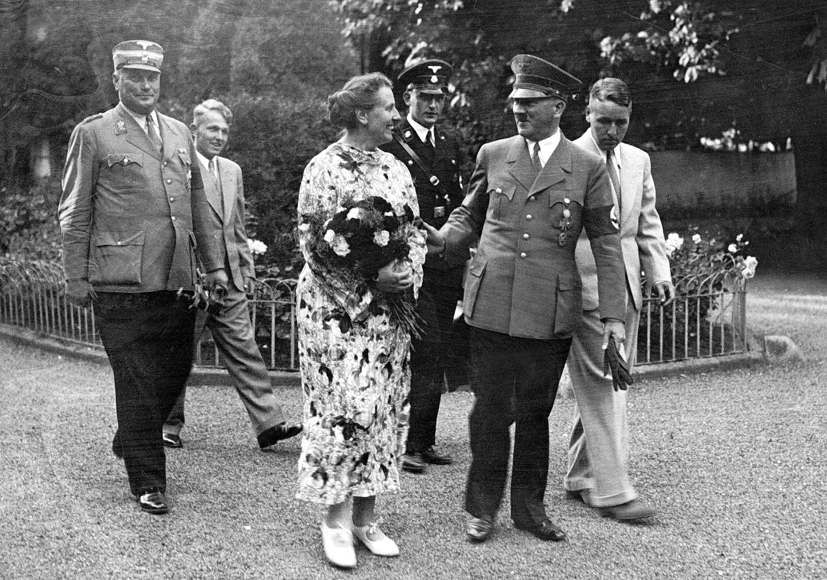 Black and white photo of Adolf Hitler with Winifred Wagner, Wolfgang Wagner, Wieland Wagner, and others.